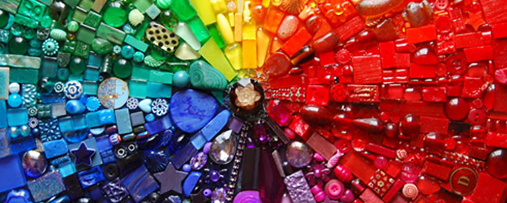 The first Home Page banner: Colorful abstract photograph featuring a collage of small bright pieces of glass. 