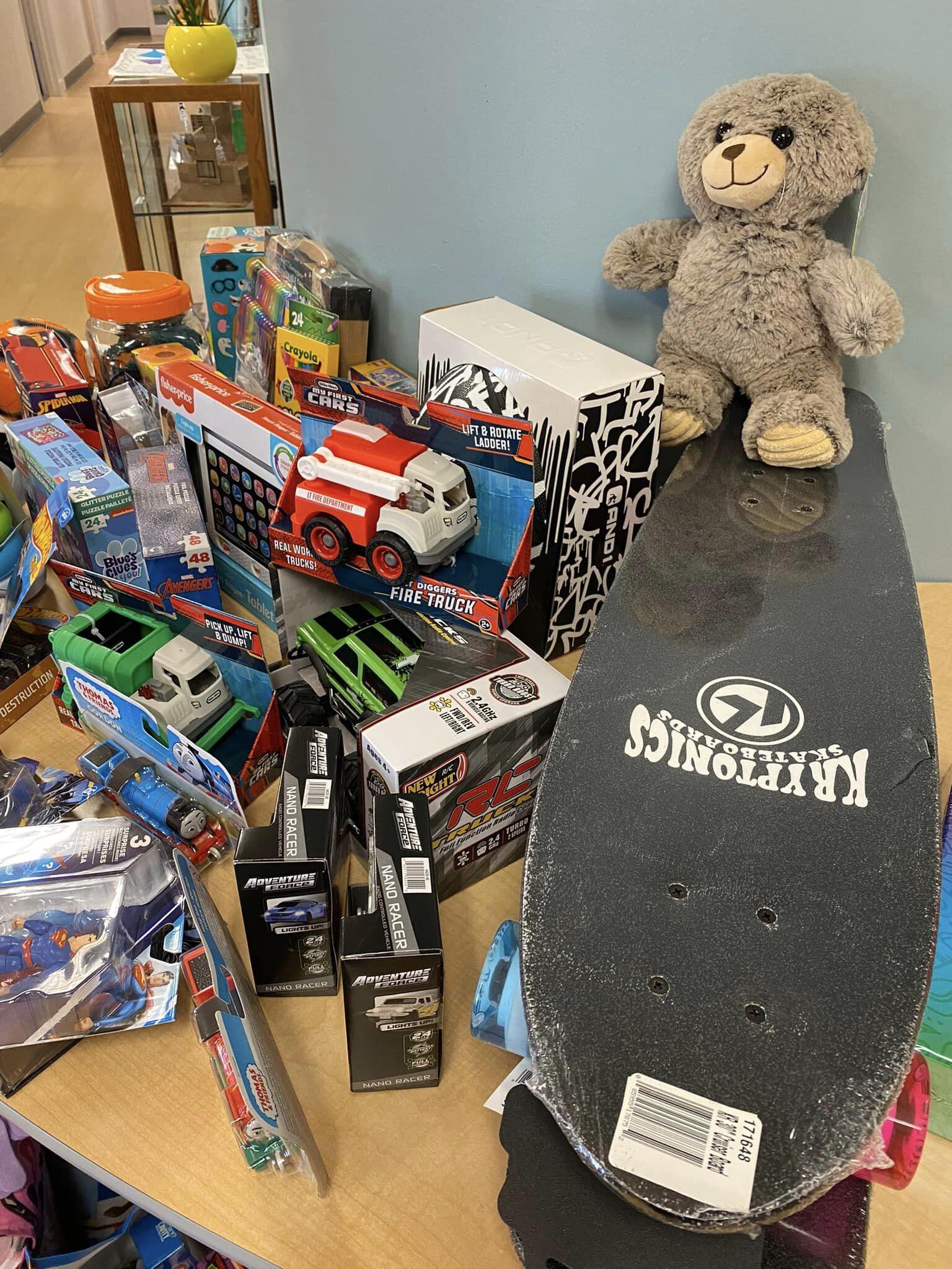 skateboards and a teddy bear on a table