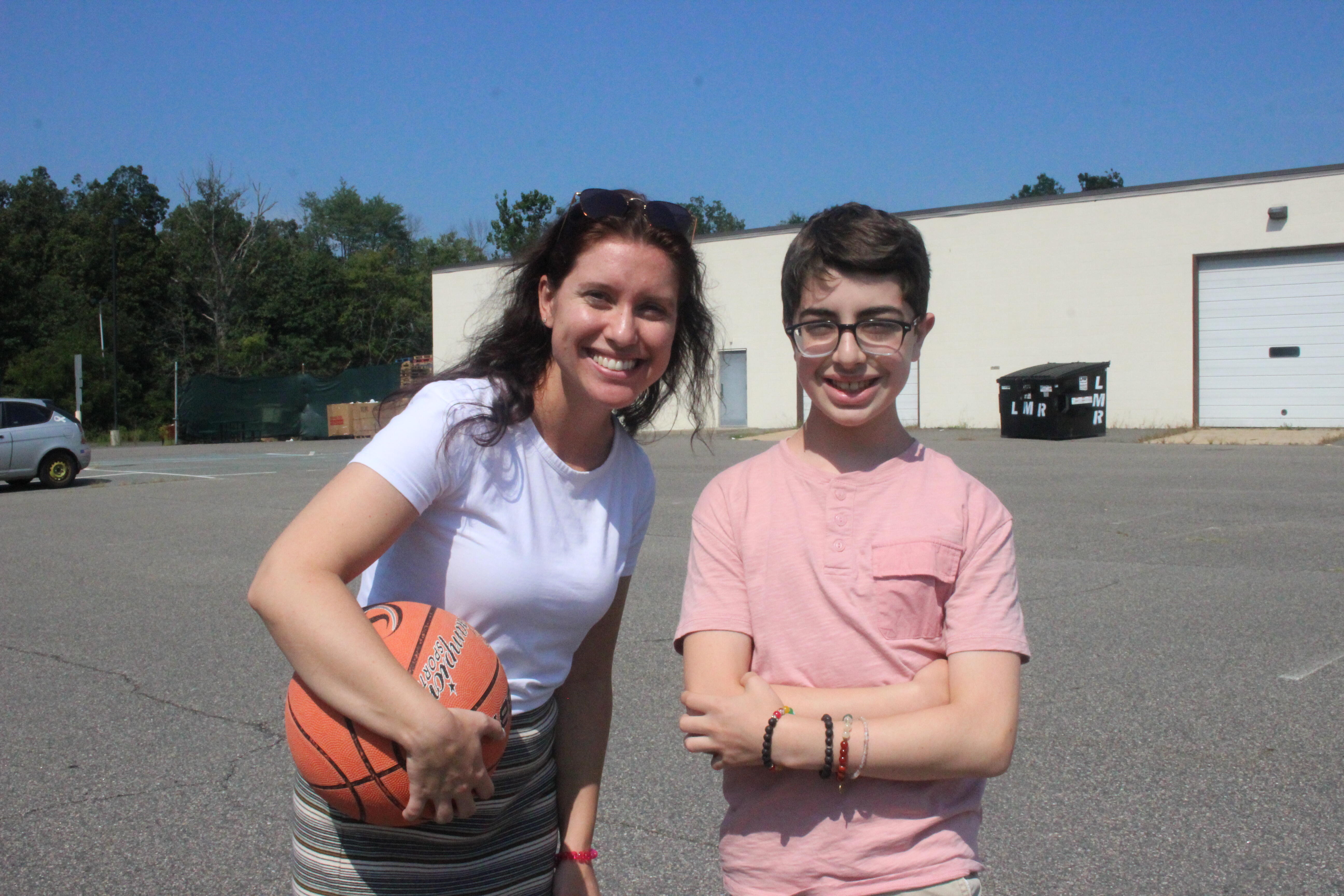 student and teacher with a basketball