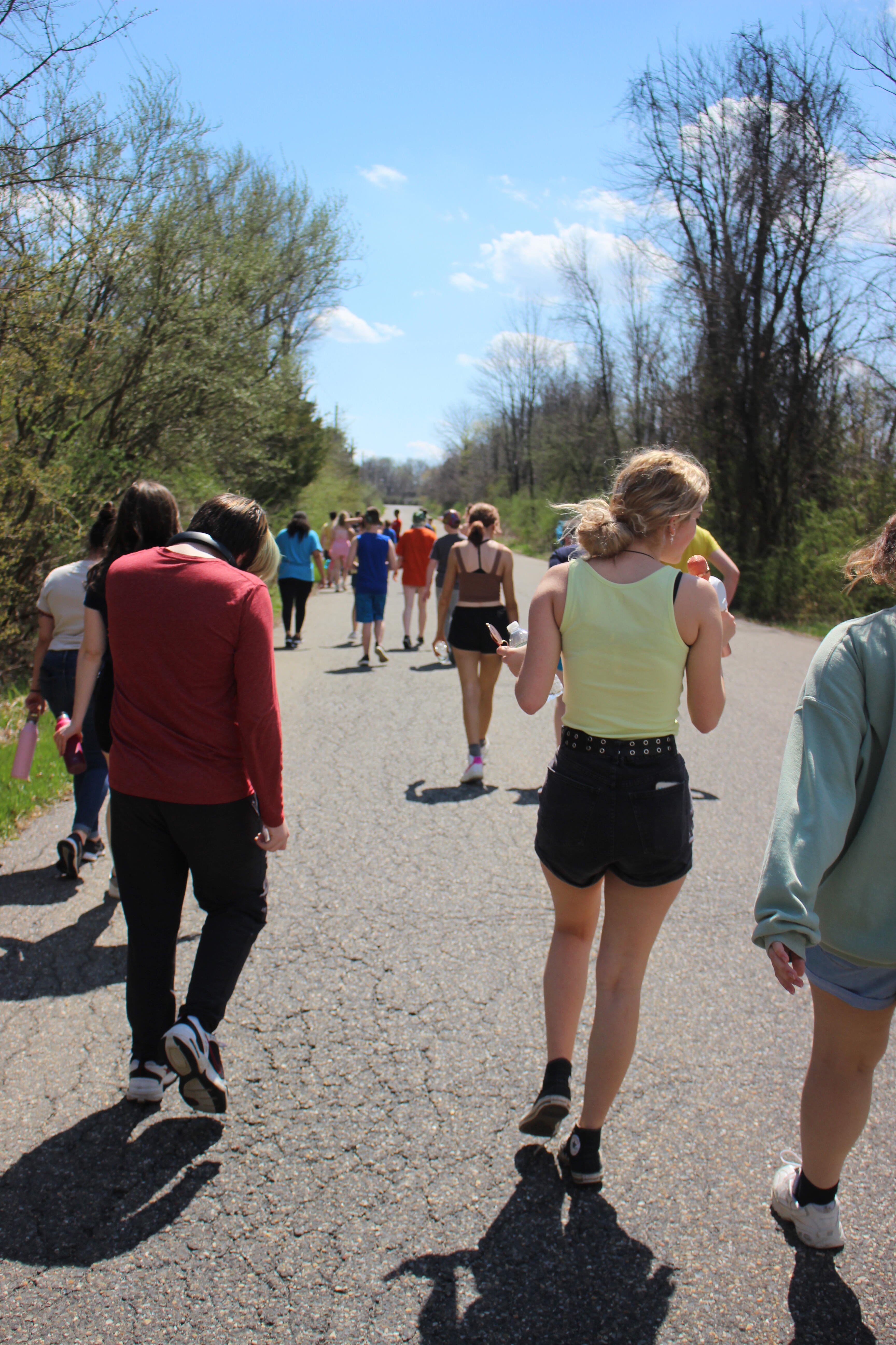 a group of students walking down the road