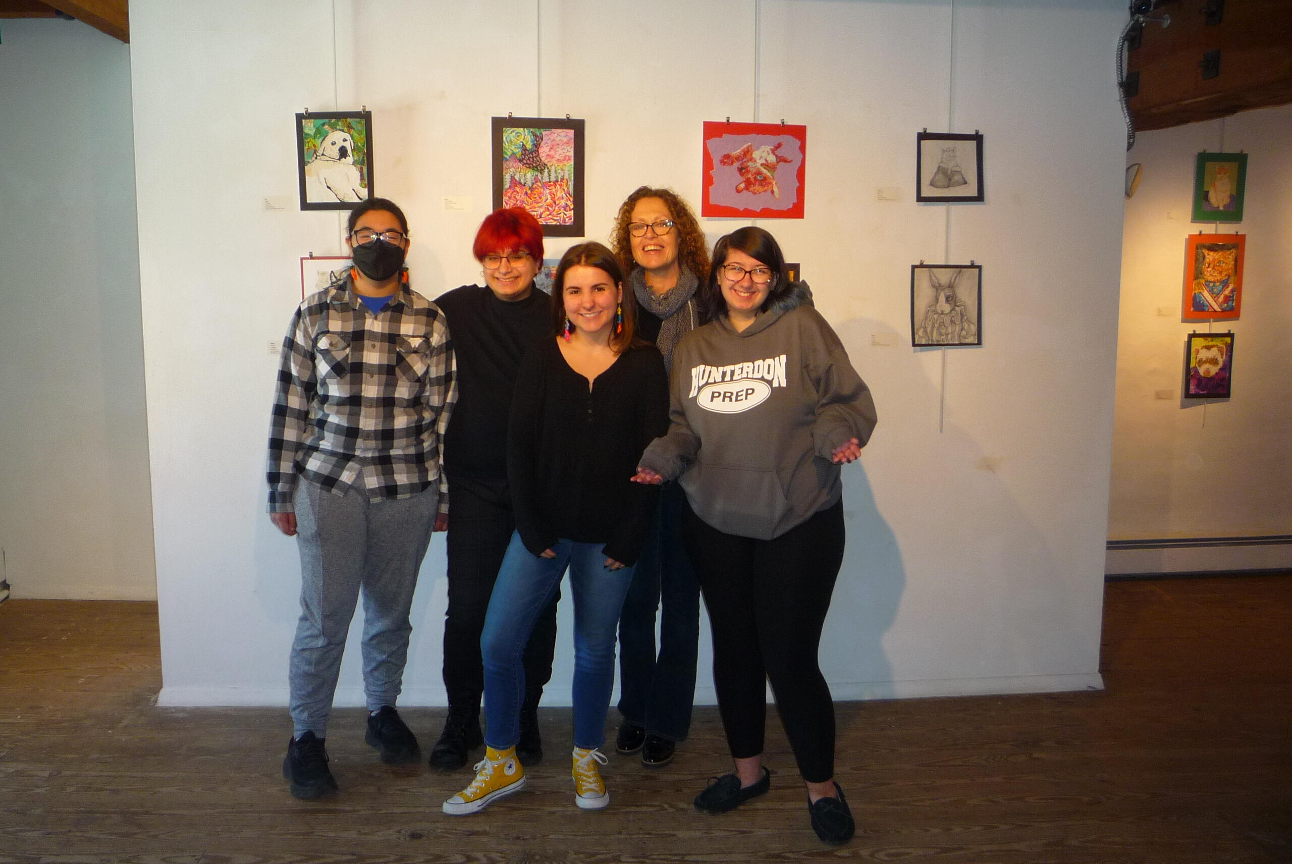 students standing in front of artwork