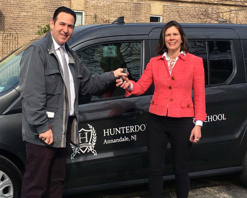 Hope Atkinson, Assistant Director, takes the keys to a new van from Peter Puglia, Flemington Car & Truck Country.