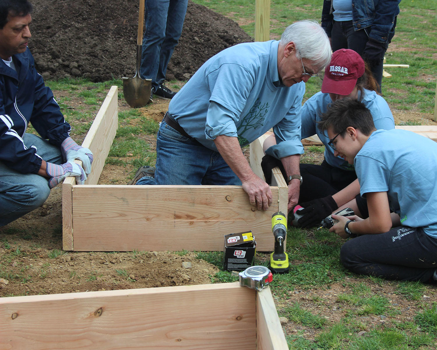 Students and volunteers building raised beds for the community garden