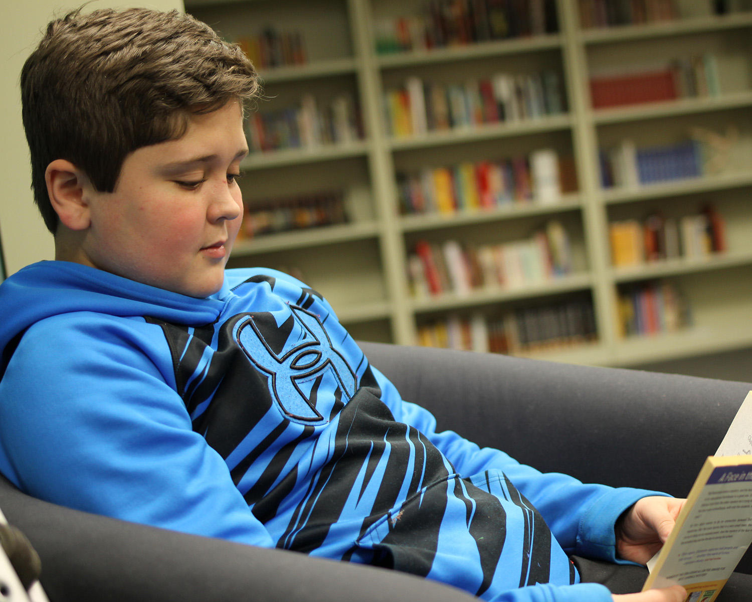 A Hunterdon Prep student reads a book in the library